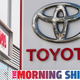 A photo of a Toyota dealership sign with the TMS banner along the bottom.